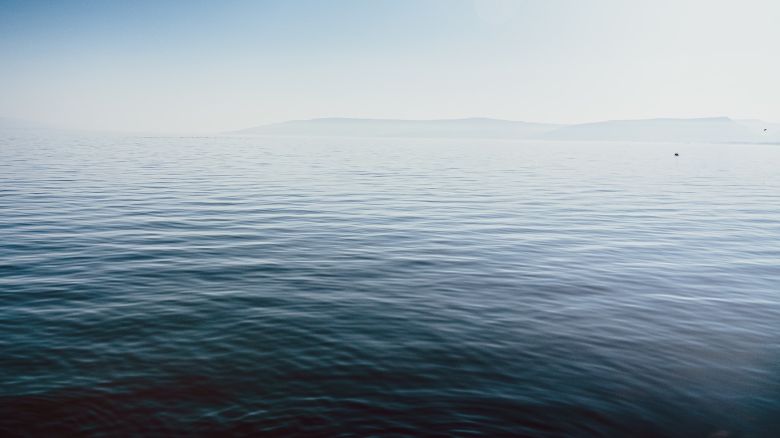 a body of water with a boat in the distance